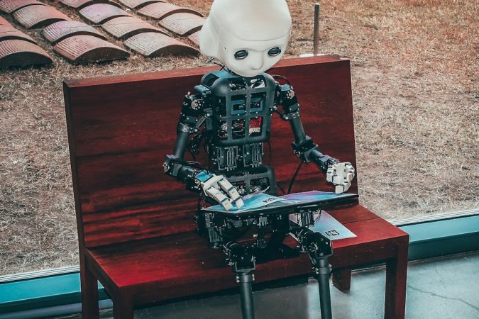 black and white robot toy on red wooden table